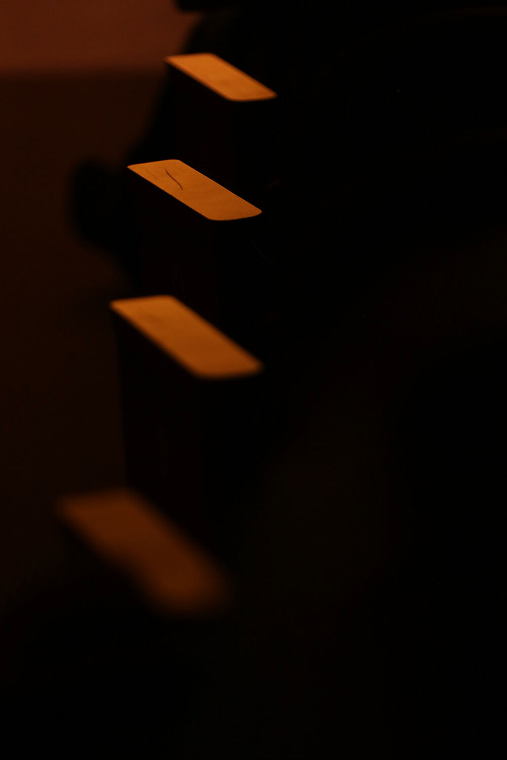 Armrests running along one aisle of the auditorium glow